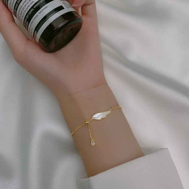 Fine S925 Sterling Silver Bracelet with Light Beads, White Shell, Wings & Tassel in Silver or Gold Finish